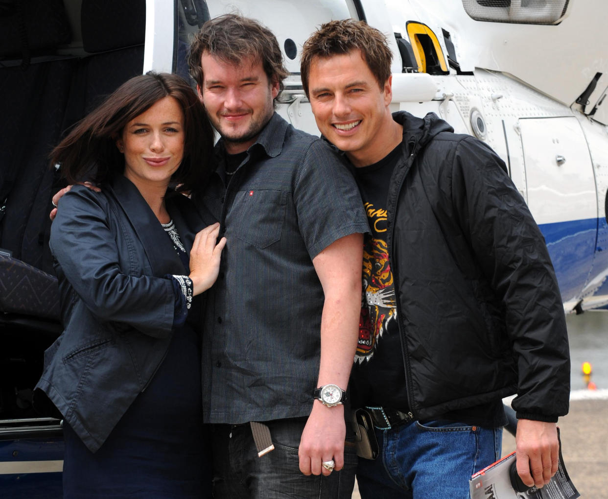 The cast of Torchwood 'Children of Earth', (left to right) Eve Myles, Gareth David-Lloyd and John Barrowman, depart London for Cardiff at London Heliport after the London launch of the DVD and Blu-Ray release of the BBC1 drama.   (Photo by Fiona Hanson/PA Images via Getty Images)