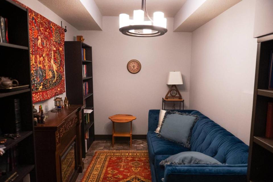 Visitors crawl through a Narnia wardrobe to enter a tornado shelter turned into the Gryffindor House common room at the Lee’s Summit home of Andreas and Becca Stabno.