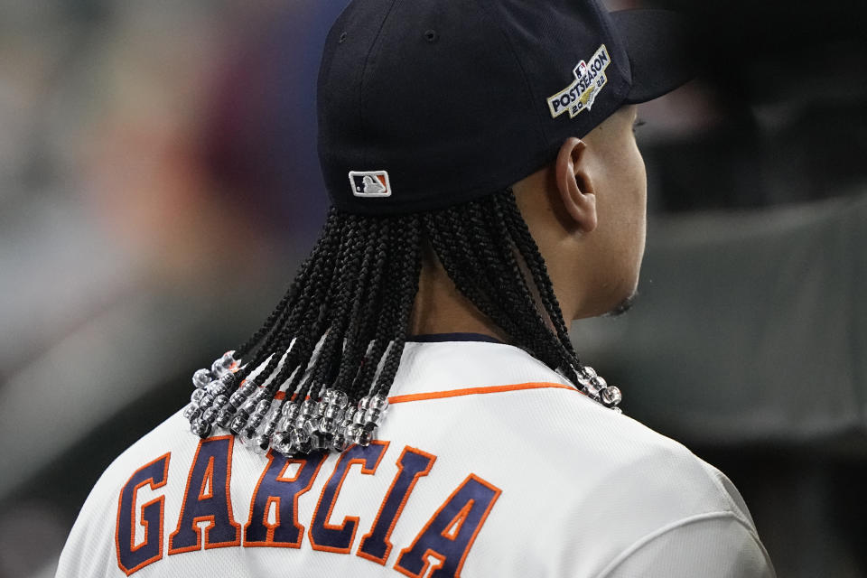Houston Astros pitcher Luis Garcia looks out toward the field before Game 1 of an American League Division Series baseball game against the Seattle Mariners in Houston, Tuesday, Oct. 11, 2022. Garcia and teammate Framber Valdez got hair extensions this season and will show off their unique locks this postseason as Houston tries to reach the World Series for the fourth time in six years. (AP Photo/David J. Phillip)