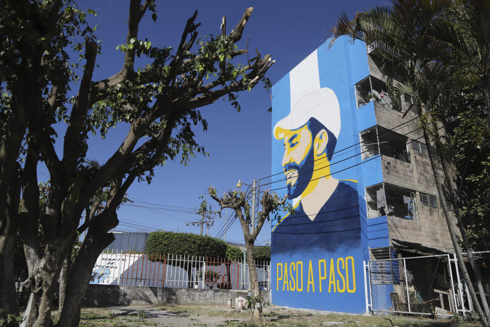 A mural promoting President Nayib Bukele, who is running for re-election, is displayed on the facade of a condominium in the Mejicanos suburb of San Salvador, El Salvador, Wednesday, Jan. 24, 2024. El Salvador will hold a general election on Feb. 4 where voters will elect a president, vice president and members of Congress. (AP Photo/Salvador Melendez)
