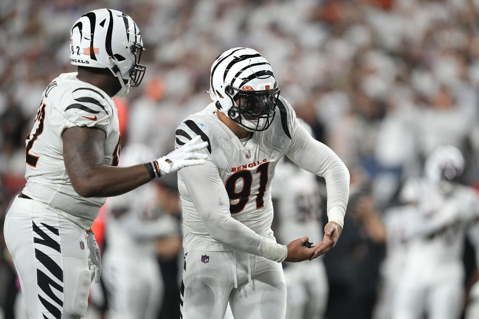 Cincinnati Bengals defensive end Trey Hendrickson (91) celebrates along with teammate B.J. Hill, left, during the second half of an NFL football game against the Los Angeles Rams Monday, Sept. 25, 2023, in Cincinnati. (AP Photo/Darron Cummings)