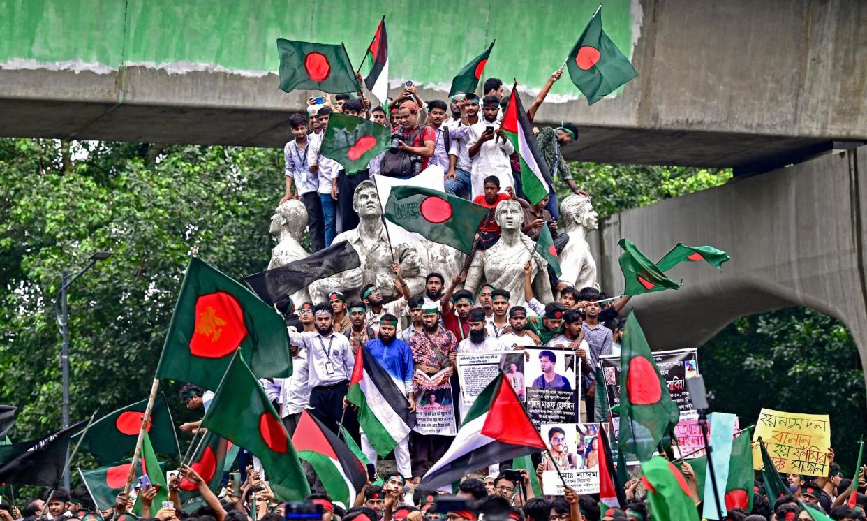 <span>Demonstrators wave Bangladesh's national flag during Martyr March to mark one month since the ousting of the country's former Prime Minister Sheikh Hasina</span><span>Photograph: Munir Uz Zaman/AFP/Getty Images</span>