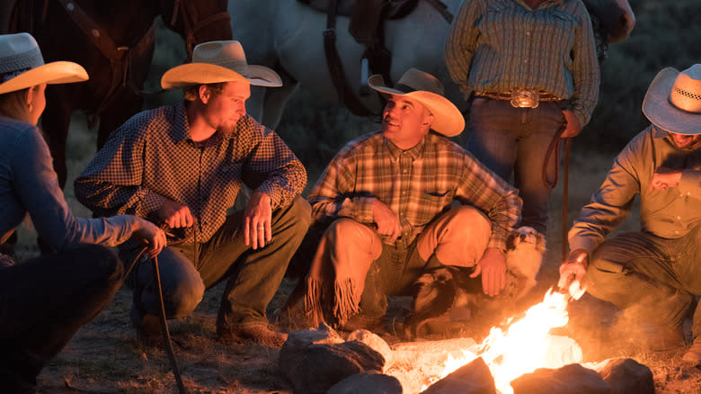 modern cowboys around fire