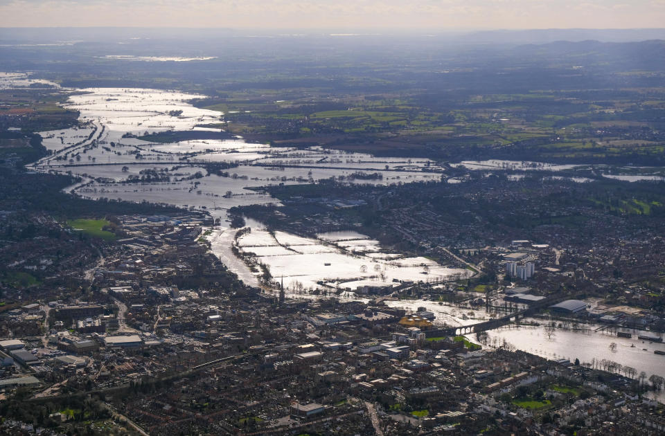 Water is seen overflowing on to land from the River Severn. The River Severn reached its highest ever level of 5.77m (19ft) on Thursday.