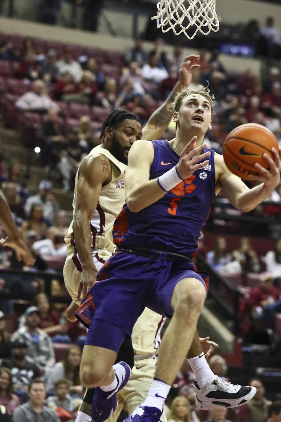 Clemson forward Hunter Tyson (5) makes a reverse layup as he gets past Florida State guard Darin Green, Jr., in back, in the first half of an NCAA college basketball game in Tallahassee, Fla., Saturday, Jan. 28, 2023. (AP Photo/Phil Sears)