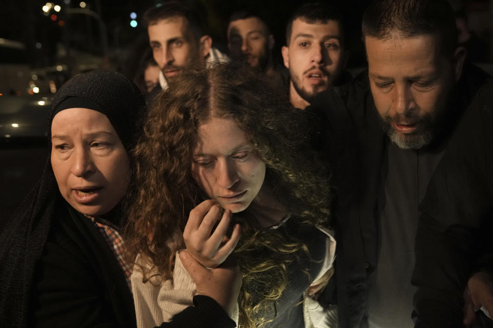 FILE - Well-known Palestinian activist Ahed Tamimi, center, is supported by her mother after she was released from prison by Israel, Thursday, Nov. 30, 2023, in the West Bank town of Ramallah. Tamimi's homecoming, along with her cousin, Wisam Tamimi, touched every home in the village of Nabi Saleh, where prison is a grim rite of passage for Palestinian boys. (AP Photo/Nasser Nasser, File)