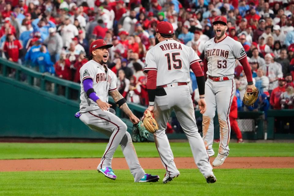 Diamondbacks second baseman Ketel Marte, third baseman Emmanuel Rivera and first baseman Christian Walker celebrate after defeating the Phillies in Game 7.