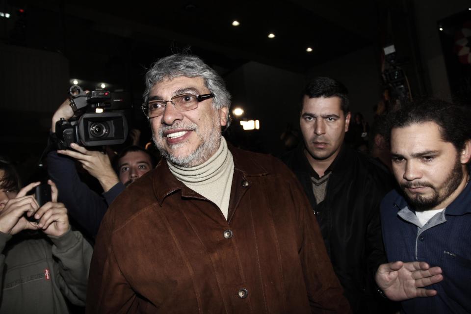 Paraguay's former President Fernando Lugo smiles after talking to his followers gathered outside the Public Television building in downtown Asuncion, Paraguay, in the early hours of Sunday, June 24, 2012. Lugo spoke in a pre-dawn special televised "open microphone" program hosted by the state-funded Public Television channel that was created by his government, to denounce his ouster as a "parliamentary coup". (AP Photo)