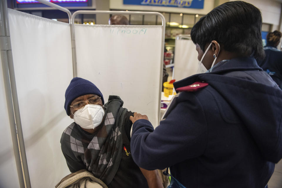 A patient is vaccinated against COVID-19 in Hammanskraal, South Africa, Tuesday, July 6, 2021. New vaccination centres are being opened as South Africa's resurgence of COVID-19 is setting record numbers of new daily cases driven by the delta variant that was first found in India. (AP Photo/Alet Pretorius)