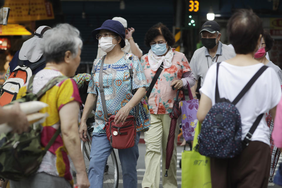 People walk on a street after Typhoon Saola moves away in Taipei, Taiwan, Thursday, Aug. 31, 2023. (AP Photo/Chiang Ying-ying)