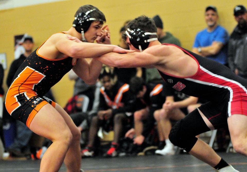 Ashland High School’s Braylen Hider wrestles New Philadelphia High School’s Konnor Tetzloff in the 190-lb class during a wrestling meet in the Reagan Elementary gymnasium Wednesday, January 26, 2022. LIZ A. HOSFELD/FOR TIMES-GAZETTE.COM