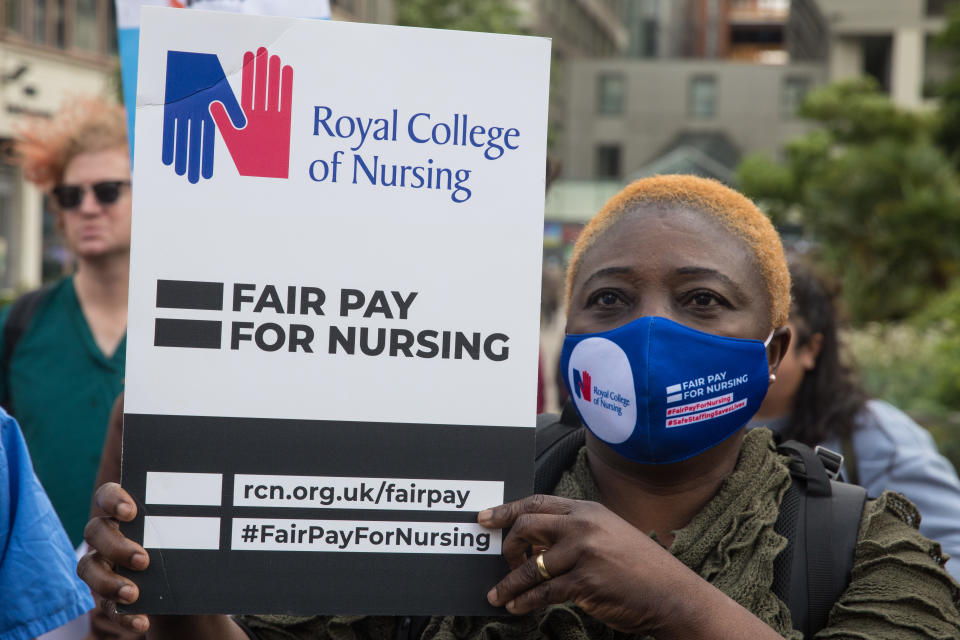 A NHS nurse prepares to march from St Thomas' Hospital to Downing Street to protest against the NHS Pay Review Body's recommendation of a 3% pay rise for NHS staff in England on 30th July 2021 in London, United Kingdom. The protest march was supported by Unite the union, which has called on incoming NHS England Chief Executive Amanda Pritchard to ensure that a NHS pay rise comes from new Treasury funds rather than existing NHS budgets and which is shortly expected to put a consultative ballot for industrial action to its members. (photo by Mark Kerrison/In Pictures via Getty Images)