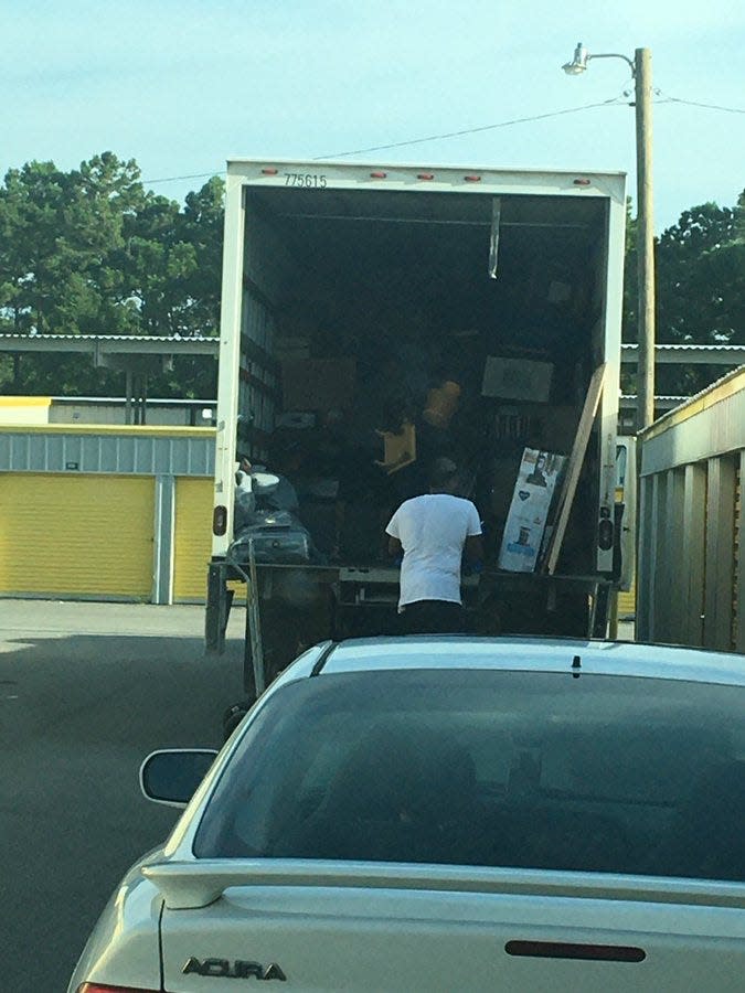 Movers unload Craig and Linda Wright's possessions Tuesday evening at Storage King USA in Ocean Springs, Miss.