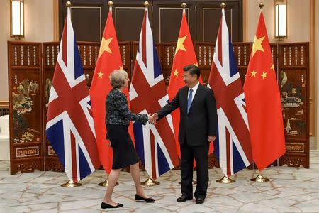 Chinese President Xi Jinping (R) shakes hand with British Prime Minister Theresa May before their meeting at the West Lake State House on the sidelines of the G20 Summit, in Hangzhou, Zhejiang province, China, September 5, 2016. REUTERS/Etienne Oliveau/Pool