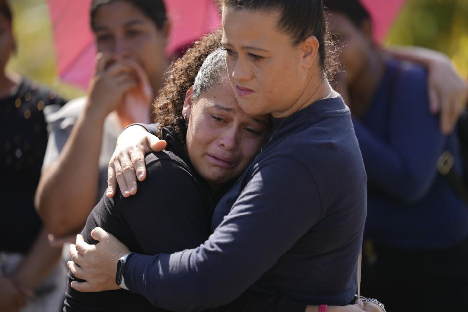 Neighbors of miner Santiago Mora attend his burial at the cemetery in La Paragua, Bolivar state, Venezuela, Thursday, Feb. 22, 2024. The collapse of an illegally operated open-pit gold mine in central Venezuela killed at least 14 people and injured several more, state authorities said Wednesday, as some other officials reported an undetermined number of people could be trapped. (AP Photo/Ariana Cubillos)