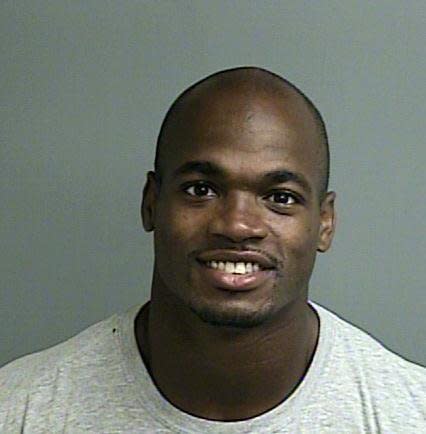 This photo provided by the Montgomery County sheriffâs office shows the booking photo of Adrian Peterson.  Peterson was indicted in Texas for using a branch to spank one of his sons and the Minnesota Vikings promptly benched him for their game Sunday, Sept. 14, 2014 against the New England Patriots. Peterson turned himself in early Saturday at a jail in Montgomery County, near Houston, where he has a home. He was processed and released.  (AP Photo/Montgomery County sheriffâs office)