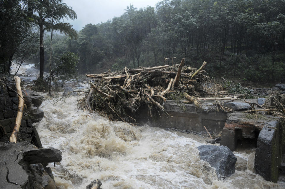 Water gushes out following heavy rain and landslide in Kozhikode, Kerala state, India, Thursday, Aug. 9, 2018. Landslides triggered by heavy monsoon rains have killed more than a dozen people in southern India, cutting off road links and submerging several villages. (AP Photo)