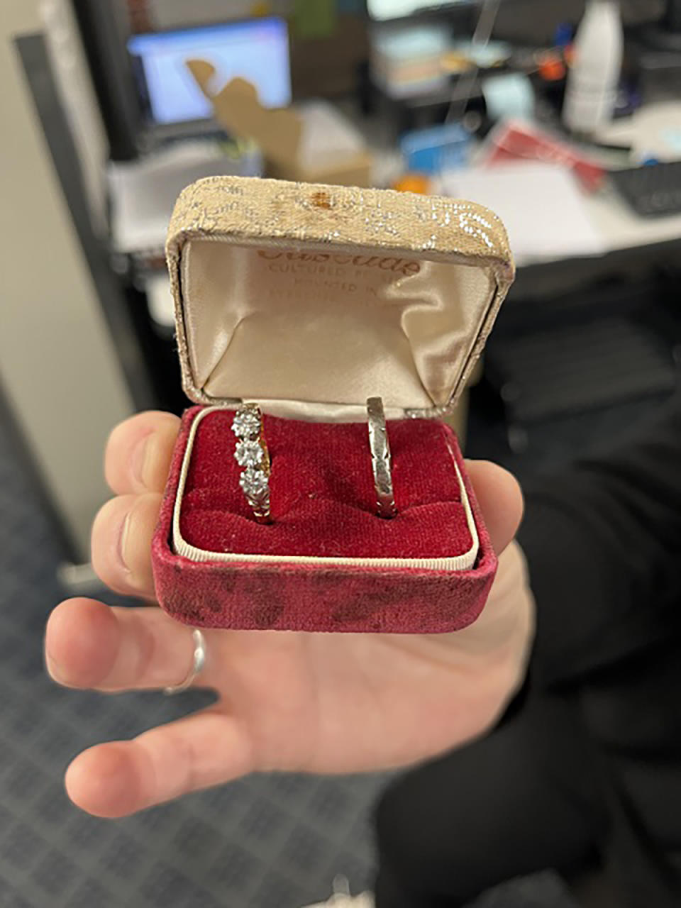 The engagement ring and wedding band in the original ring box. 