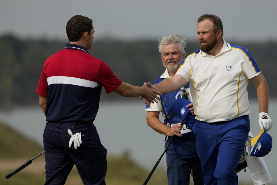 Team USA's Patrick Cantlay shakes hands with Team Europe's Shane Lowry after winning a Ryder Cup singles match at the Whistling Straits Golf Course Sunday, Sept. 26, 2021, in Sheboygan, Wis. (AP Photo/Jeff Roberson)