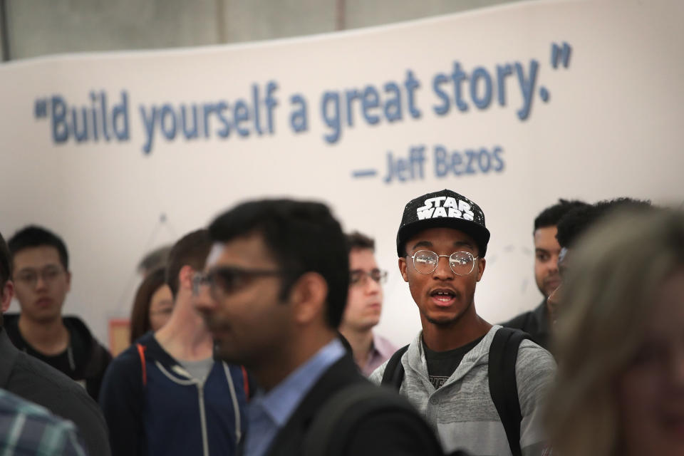 CHICAGO, ILLINOIS - SEPTEMBER 17: Job seekers wait in line to speak with Amazon recruiters and other company volunteers about job opportunities at Amazon during a career fair held at Vertiport Chicago on September 17, 2019 in Chicago, Illinois. The event was one of several Amazon career fairs held across the country today as the company attempts to fill more than 30,000 full and part-time positions. (Photo by Scott Olson/Getty Images)