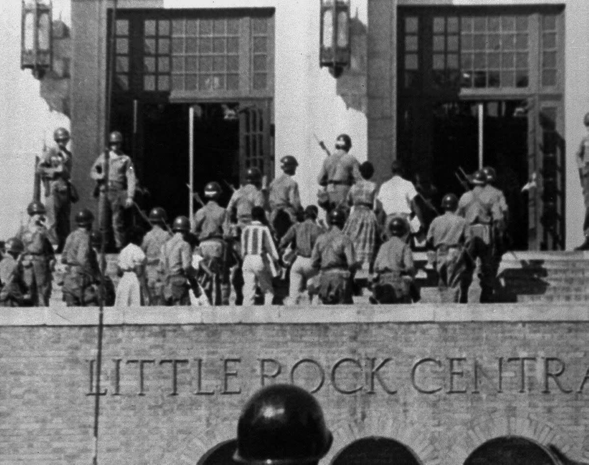 The U.S. Army’s 101st Airborne Division troops escort nine African-American students into Little Rock Central High School on Sept. 25, 1957, in Little Rock, Ark. After Gov. Faubus posted National Guard troops to block the teens' way three earlier on what was supposed to be their first day of class, President Eisenhower ordered federal troops to escort them in the school. It was the first major physical confrontation over states' rights and school desegregation after the landmark Supreme Court decision in Brown v. Board of Education of Topeka, Kan. (1954), stating segregation of public schools is a violation of the 14th amendment and therefore unconstitutional.
