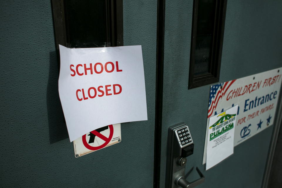 A sign taped to the front door of Pulaski International School of Chicago reads: School Closed.