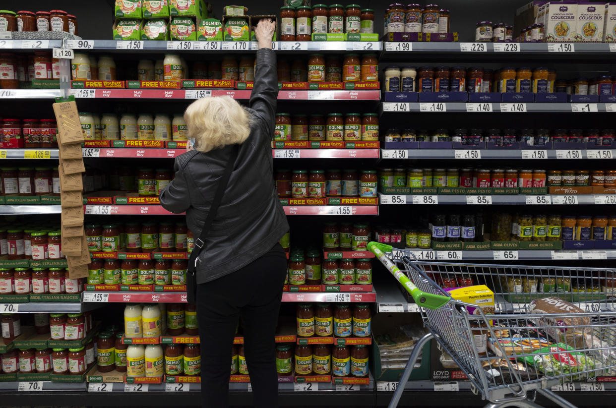 An older woman in an Asda superstore reaches past shelves of various pasta sauces, a common household staple, for the Dolmio brand sauce, as supermarkets in the country slash prices to compete for customers amid an ongoing cost of living crisis on 25th April, 2022 in Leeds, United Kingdom. (photo by Daniel Harvey Gonzalez/In Pictures via Getty Images)