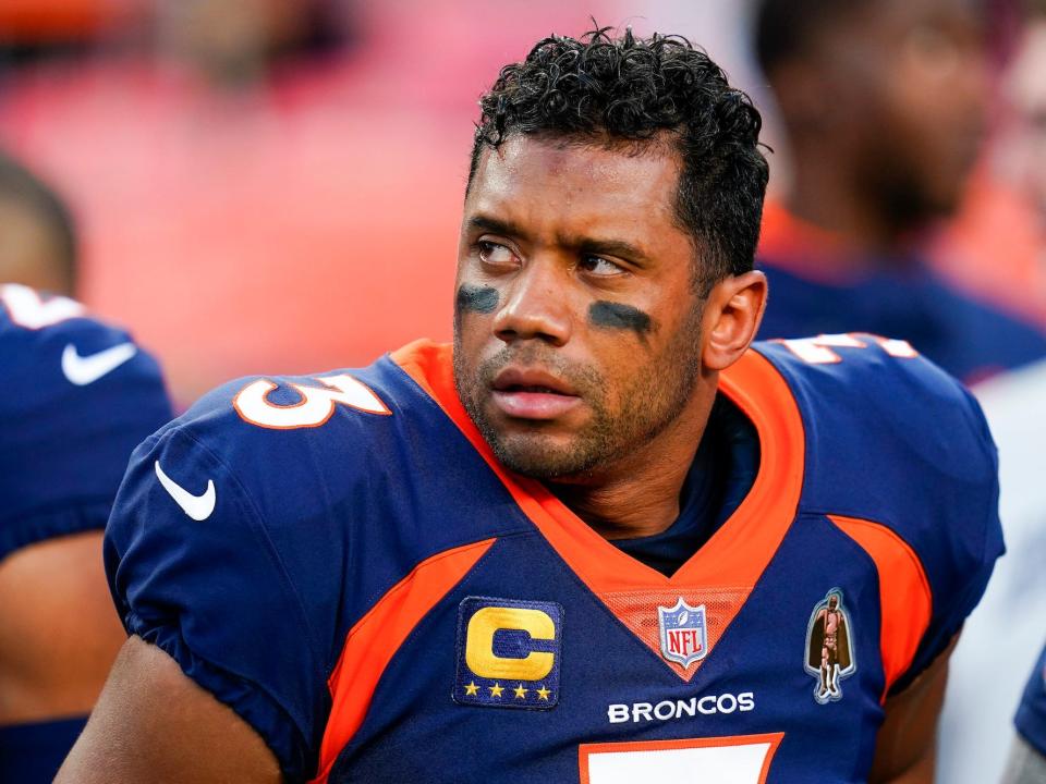 Russell Wilson looks off to the side during a Broncos game.