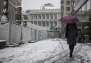 A person walks in front of Palais Coburg where closed-door nuclear talks take place in Vienna, Austria, Thursday, Dec. 09, 2021. (AP Photo/Michael Gruber)