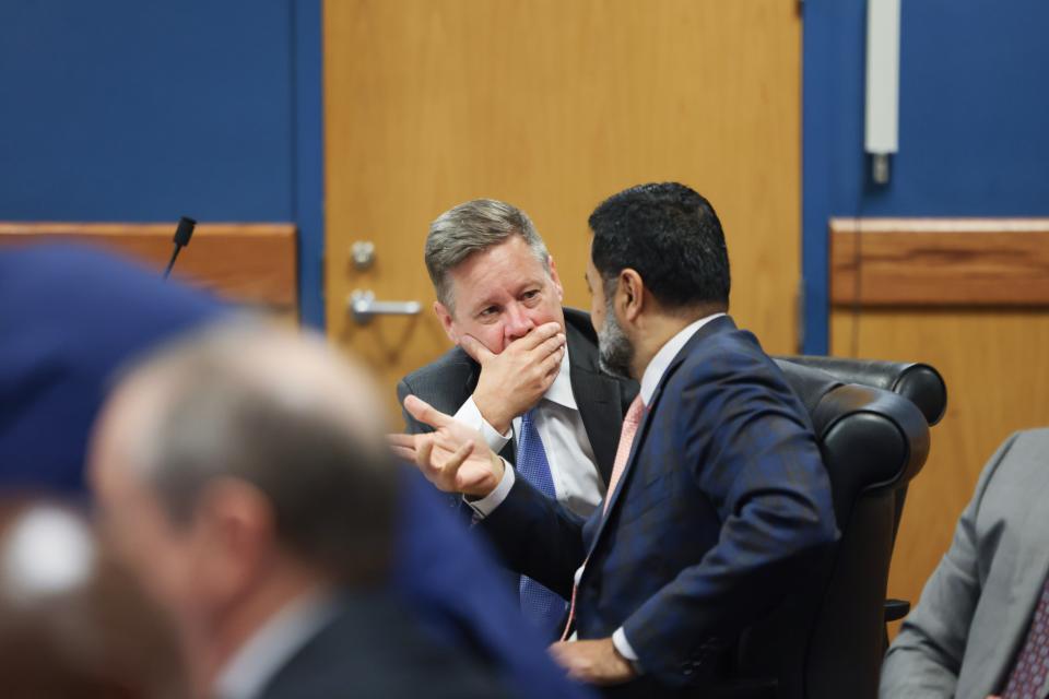 Attorneys Brian Rafferty, left, representing Sidney Powell, and Manny Arora, representing Ken Chesebro, confer as Fulton County Superior Judge Scott McAfee hears motions in Atlanta on Sept. 6.