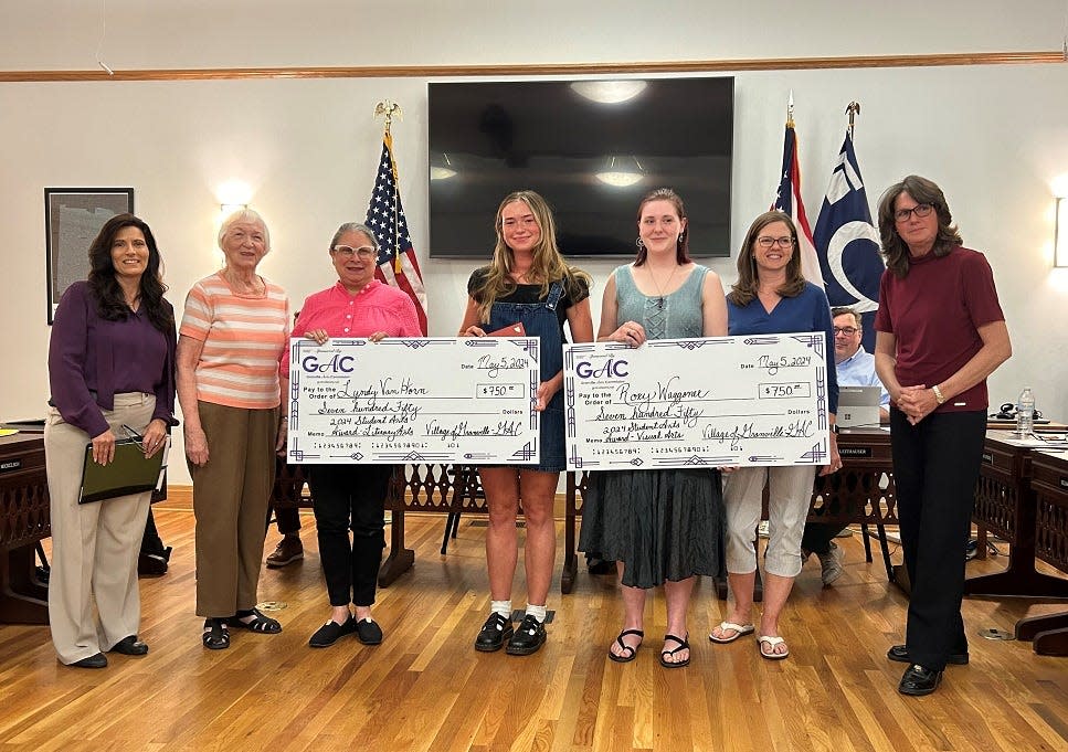 Granville High School seniors Lyndy Van Horn, fourth from the left, and Roxy Waggoner, third from the right, were presented with $750 checks from the Granville Arts Commission during a May 1 Granville Village Council meeting.