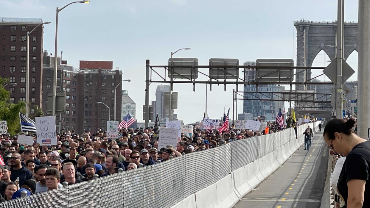 Thousands of NYC municipal employees march over the Brooklyn Bridge roadway towards lower Manhattan, New York on Monday, Oct. 25, 2021.