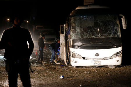 Police officers inspect a scene of a bus blast in Giza, Egypt, December 28, 2018. REUTERS/Amr Abdallah Dalsh