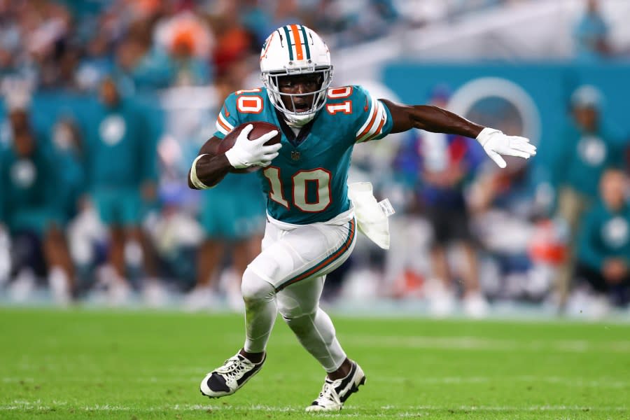 MIAMI GARDENS, FLORIDA – DECEMBER 24: Tyreek Hill #10 of the Miami Dolphins carries the ball against the Dallas Cowboys during the fourth quarter of the game at Hard Rock Stadium on December 24, 2023 in Miami Gardens, Florida. (Photo by Megan Briggs/Getty Images)