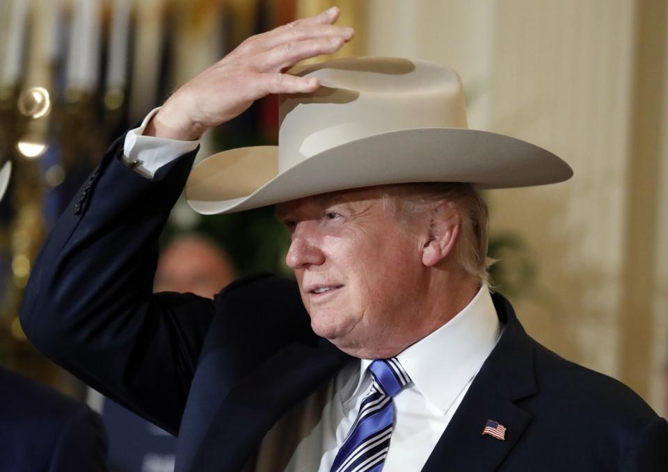 <p>President Trump tries on a Stetson hat during a “Made in America,” product showcase featuring items created in each of the 50 U.S. states on July 17, 2017, at the White House in Washington. Stetson is based in Garland, Tex. (AP Photo/Alex Brandon) </p>