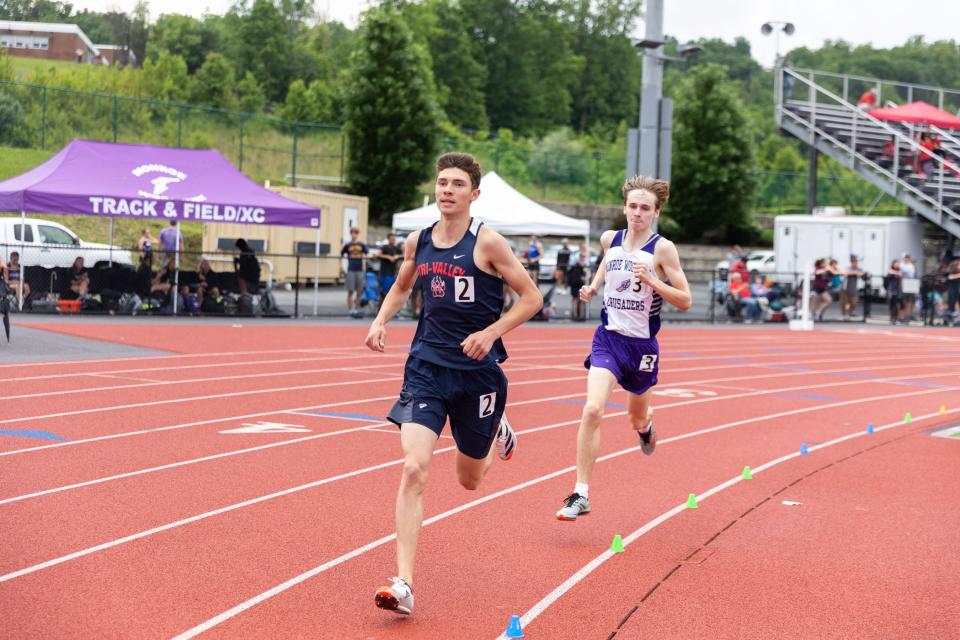 Tri-Valley's Adam Furman, left, and Monroe-Woodbury's Collin Gilstrap, right, duel in the boys 3,200-meter run. Gilstrap ran fast splits on his final two laps to beat Furman. Both qualified for the state meet. ALLYSE PULLIAM/For the Times Herald-Record
