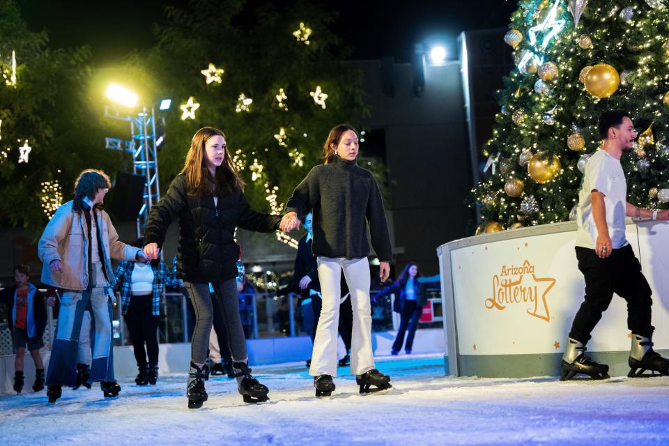 Megan Beresford and Gianna Chavez ice skate at CityScape's CitySkate Ice Rink in Phoenix.