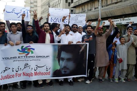 People chant slogans and hold signs as they condemn the death of Naqibullah Mehsud, whose family said he was killed by police in a so-called "encounter killing", during a protest in Karachi, Pakistan January 21, 2018. REUTERS/Akhtar Soomro/Files