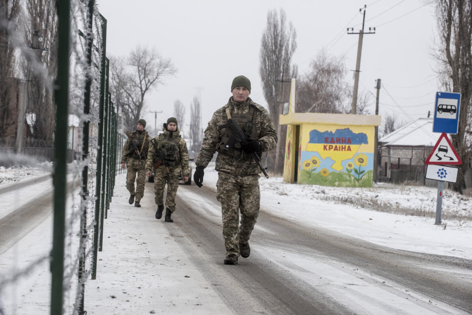 Ukrainian border guards patrol an area along the Ukrainian side of the Ukraine - Russia border in Milove town, eastern Ukraine, Sunday, Dec. 2, 2018. On a map, Chertkovo and Milove are one village, crossed by Friendship of Peoples Street which got its name under the Soviet Union. On the streets in both places, people speak a mix of Russian and Ukrainian without turning choice of language into a political statement as many did after the question of language became one of the many thorny issues that has fueled the conflict between Ukraine and Russia since Moscow annexed Crimea in March 2014 and threw its weight behind separatists in the east by clandestine dispatches of troops and weapons. (AP Photo/Evgeniy Maloletka)