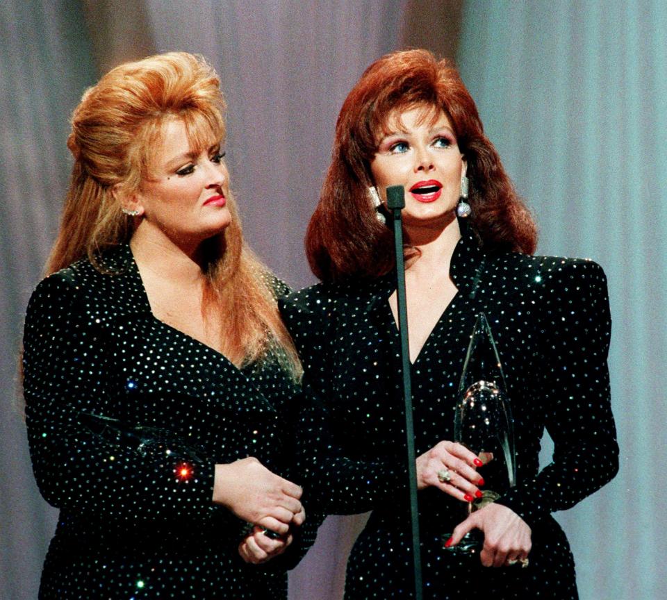 In an emotional farewell, Wynonna, left, and Naomi Judd accept their eighth consecutive CMA award during the 25th annual CMA Awards show at the Grand Ole Opry House Oct. 2, 1991. The Judds are breaking up as an act after a Dec. 4 concert in Murfreesboro because Naomi is retiring because of a lingering case of hepatitis.