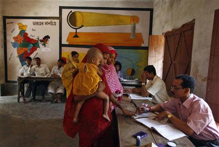 A woman gets her finger marked with ink before casting her vote at a polling station, in Malda district of the eastern Indian state of West Bengal April 24, 2014. REUTERS/Rupak De Chowdhuri