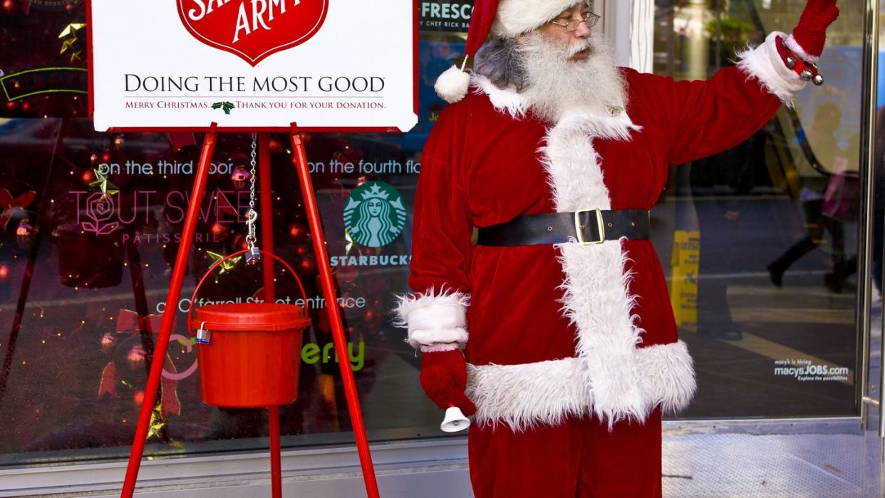 person dressed as santa claus ringing bell for salvation army donations