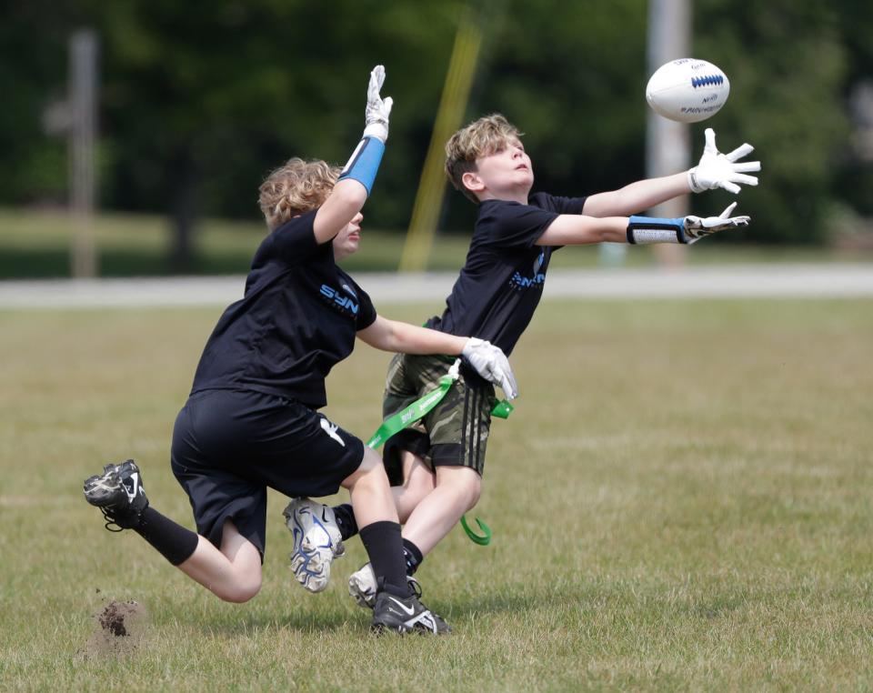 Camden Graper, 10, tries to make the catch during a Howard-Suamico Youth Flag Football practice on Friday at Idlewild Park in Suamico before the NFL FLAG Football regional tournament at the Green Bay Packers' Ray Nitschke Field.