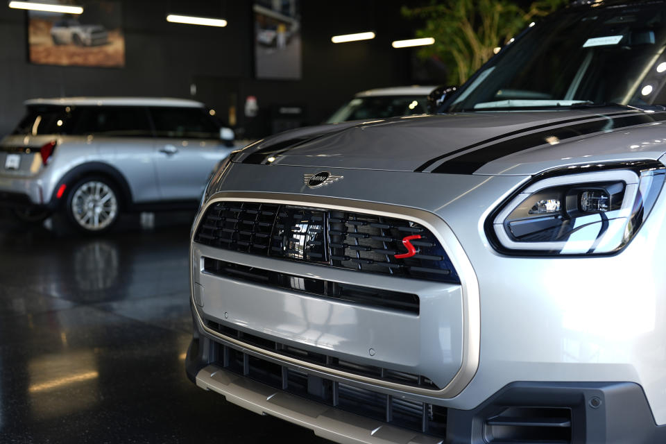 Unsold 2025 Cooper S hardtops and Countryman S utility vehicles sit on display in the showroom of a Mini dealership Wednesday, Sept. 4, 2024, in Highlands Ranch, Colo. (AP Photo/David Zalubowski)