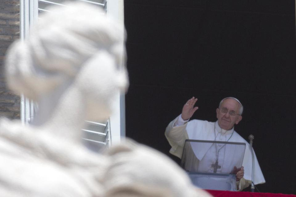 FILE -- In this file photo taken on Aug. 11 2013, Pope Francis delivers his blessing during the Angelus noon prayer he celebrated from the window of his studio overlooking St. Peter's Square, at the Vatican. On Sunday mornings when the pope is in Rome, pilgrims, tourists and Romans flock to St. Peter’s Square, intent on glimpsing the pontiff at his studio window as he speaks to the crowd below. (AP Photo/Andrew Medichini)