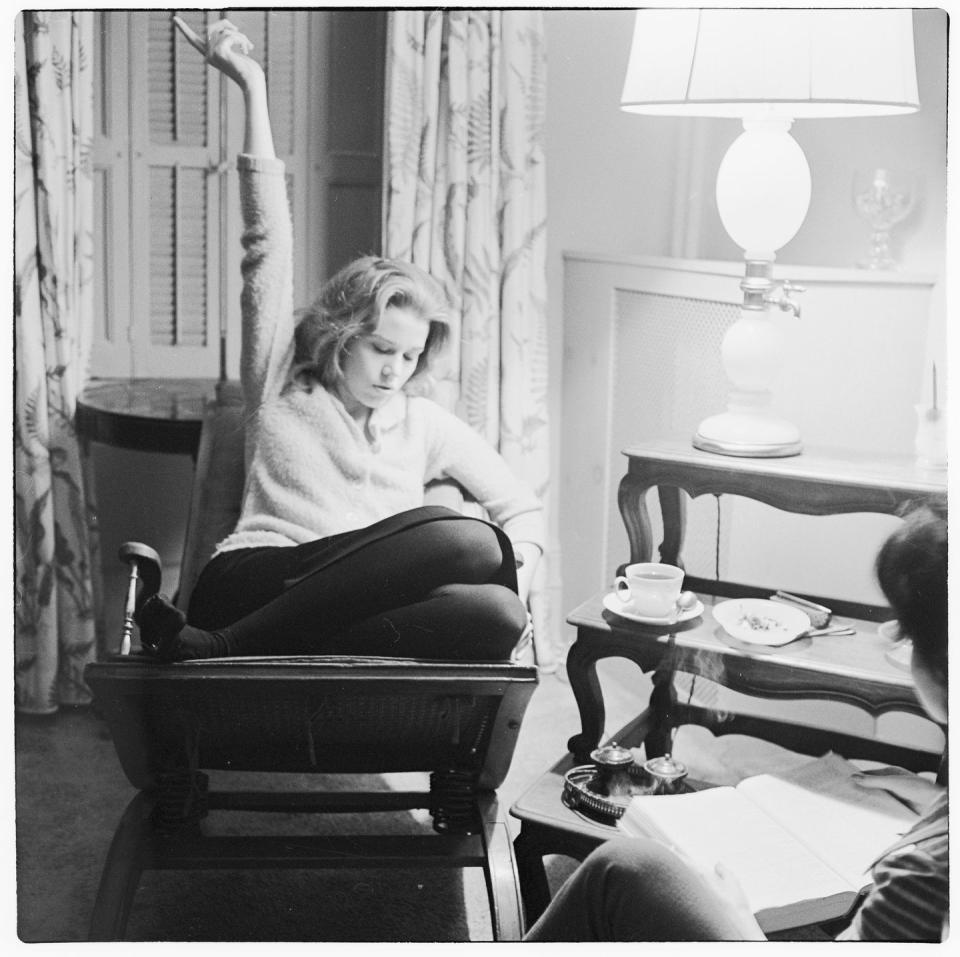 <p>Jane Fonda curls up in an armchair and studies the lines for her upcoming part in Lee Strasberg's acting program. </p>