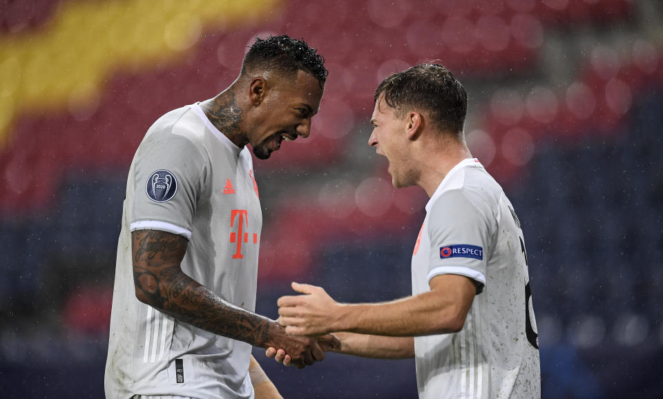 Jerome Boateng and Joshua Kimmich face each other and yell in celebration.