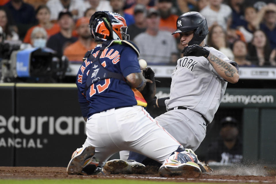 New York Yankees' Gary Sanchez, right, slides safely past Houston Astros catcher Martin Maldonado during the third inning of a baseball game, Sunday, July 11, 2021, in Houston. (AP Photo/Eric Christian Smith)