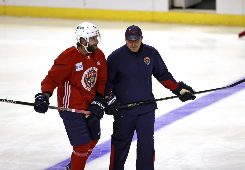 Florida Panthers assistant coach Andrew Brunette, right, skates with defenseman Aaron Ekblad (5) during an NHL hockey training camp Thursday, Sept. 23, 2021, in Sunrise, Fla. (David Santiago/Miami Herald via AP)