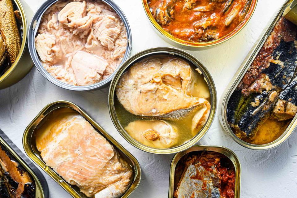 <p>Ilia Nesolenyi / Getty Images</p> Various tinned seafoods